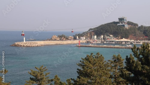 Jangho Port, Samcheok City, South Korea - December 29, 2023: A wider shot capturing the expansive beauty of Jangho Port, with the Samcheok Marine Cable Car traversing above. photo