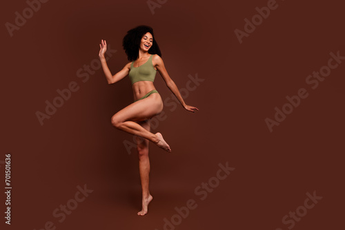 No retouch full length photo of beautiful stunning girl thin waist legs sporty body look empty space isolated on brown color background