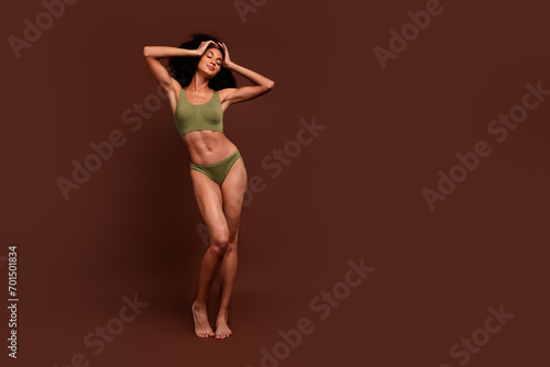 No filter full length photo of gorgeous girl sporty strong ideal body wear khaki lingerie empty space isolated on brown color background