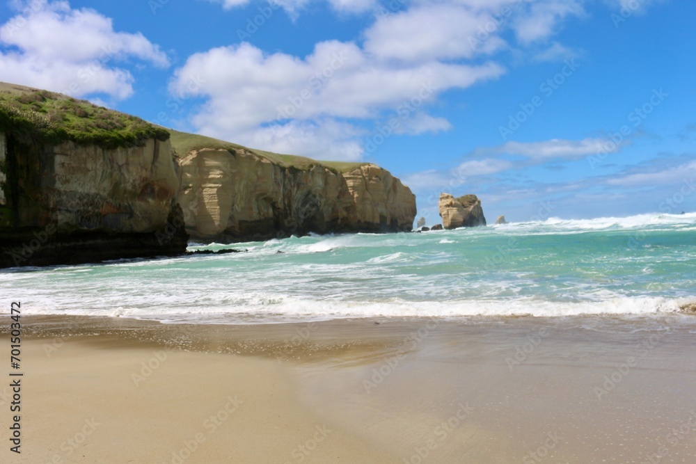 New Zealand beach green sea water and cliffs rocks