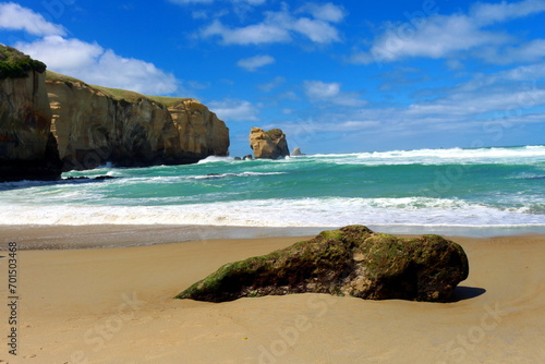 New Zealand beach green sea water and cliffs rocks © LetsSeeGoodWaves