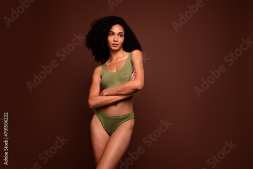 No filter studio photo of thoughtful dreamy woman wear lingerie arm folded looking empty space isolated brown color background © deagreez