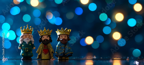 Abstract background for Three Kings day, Dia de los Reyes Magos, Epiphany day holiday celebration night. Small figures of three wise men on navy blue background with bokeh lights photo