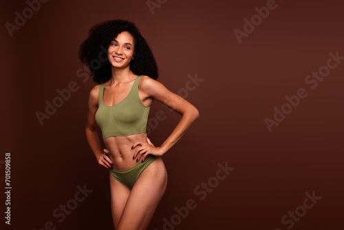 No filter studio photo of adorable dreamy woman wear lingerie enjoying body positive empty space isolated brown color background © deagreez