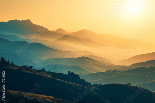 Sunrise above the misty mountains landscape in gold and dark cyan