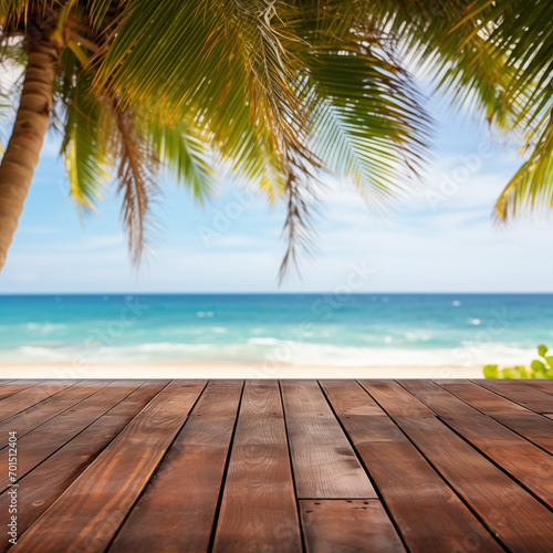 A wooden table on an exotic beach, palm leaves on a blurry background, with the blue ocean in the background. Holiday atmosphere
