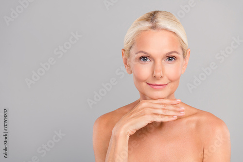 Portrait of retired woman touch chin plan plastic surgery rejuvenating procedure feel skin young isolated on grey color background