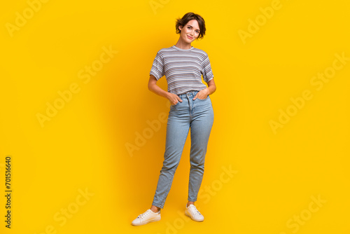 Full length photo of positive glad woman posing in stylish clothes new summer spring collection isolated on yellow color background