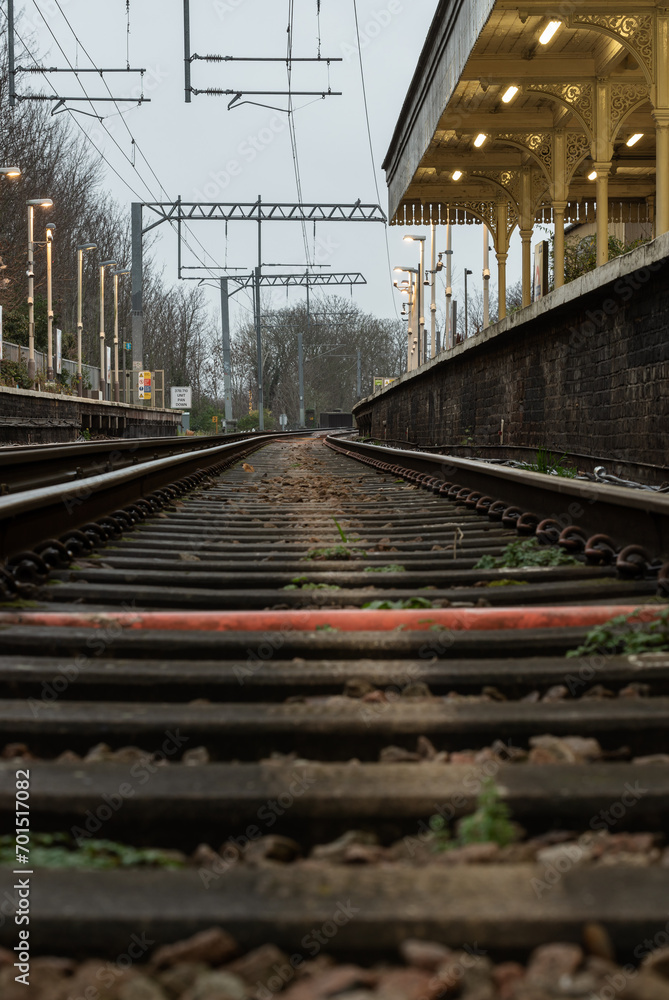 Railway iron rails from the low perspective. Railroad tracks with limited depth of focus, The Railway system with Metal frames of Train platform, Railroad track rails, Train tracks, Railway station,