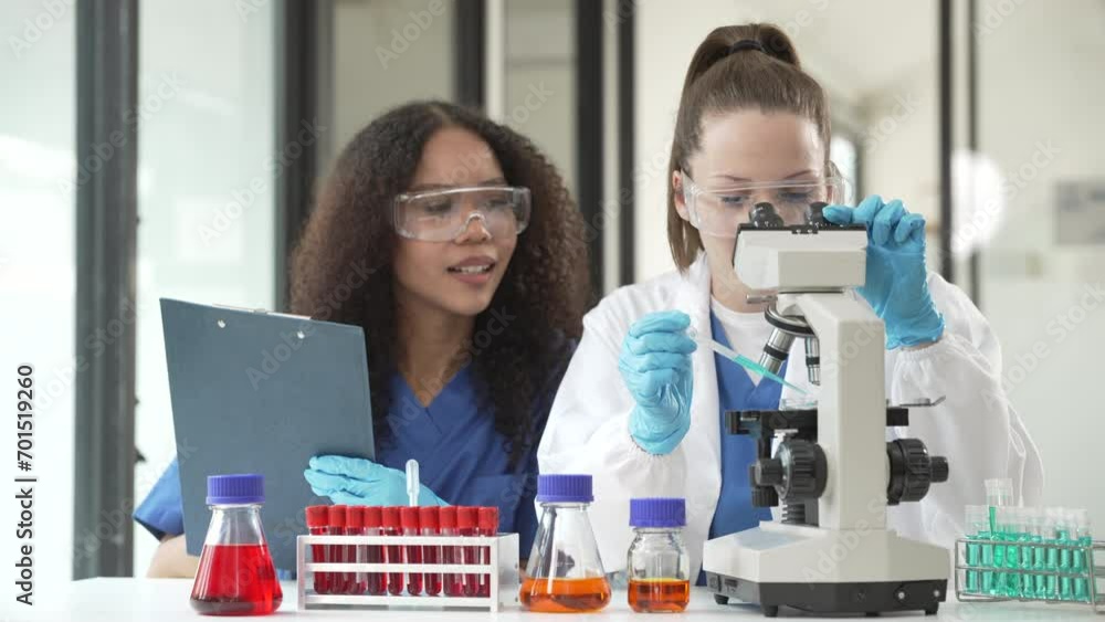 Caucasian and an African American doctor examining a spine and knee bone model, discussing medical details. Caucasian and an African American doctor examining a spine and knee bone model, discussing medical details.