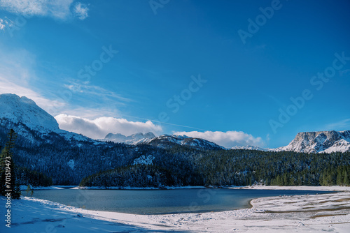 Snow-covered shore of the Black Lake at the foot of the mountains. Durmitor National Park, Montenegro