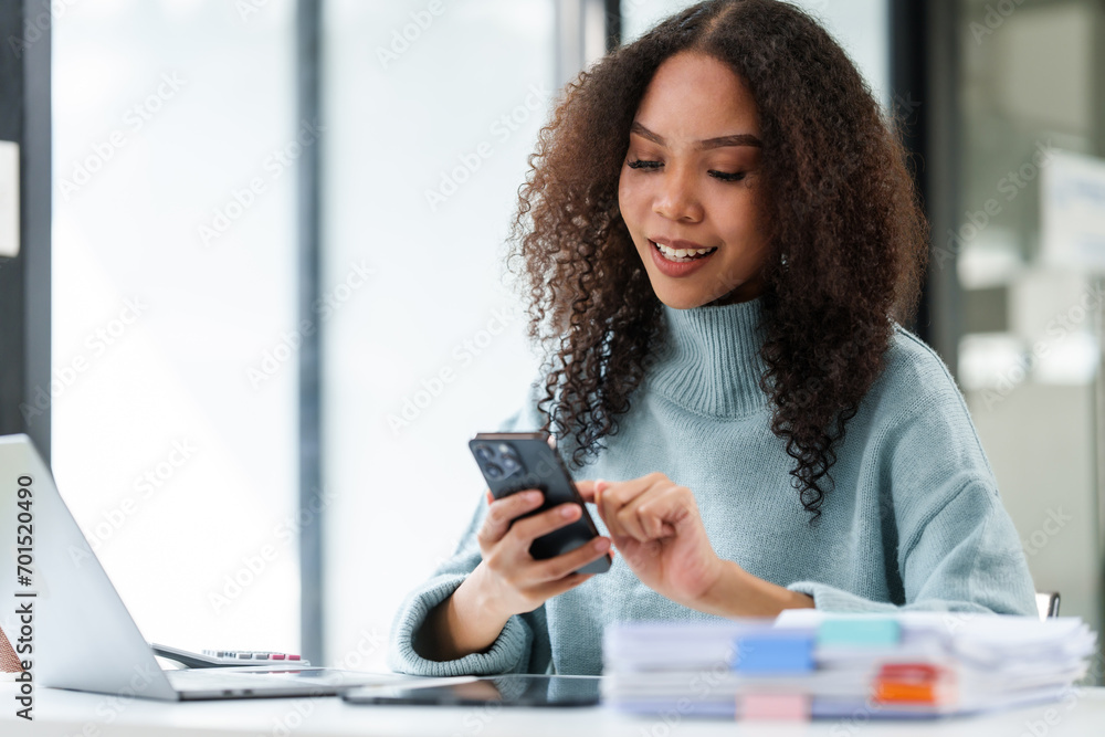 African American university student focused on working on her MBA project on a laptop in a study area. African American university student focused on working on her MBA project on a laptop in a study area.