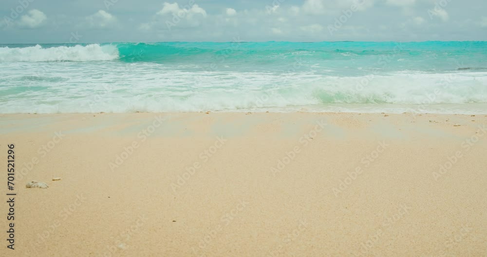 Turquoise sea waves on golden sand. Ocean water and smooth beach background. Turquoise sea waves on golden sand. Ocean water and smooth beach background.