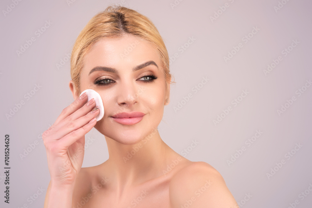 Woman with cotton pad. Toner for cleaning make up. Clean healthy skin, studio background. Beauty woman holding cotton pad, applying cleansing lotion facial wipe on face, removing makeup. Woman with cotton pad. Toner for cleaning make up. Clean healthy skin, studio background. Beauty woman holding cotton pad, applying cleansing lotion facial wipe on face, removing makeup.