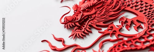 Close up of red paper cut art of Chinese dragon isolated on one side of white background with copy space, 3d paper cutting Chinese new year celebration background with space for text, greeting cards. photo