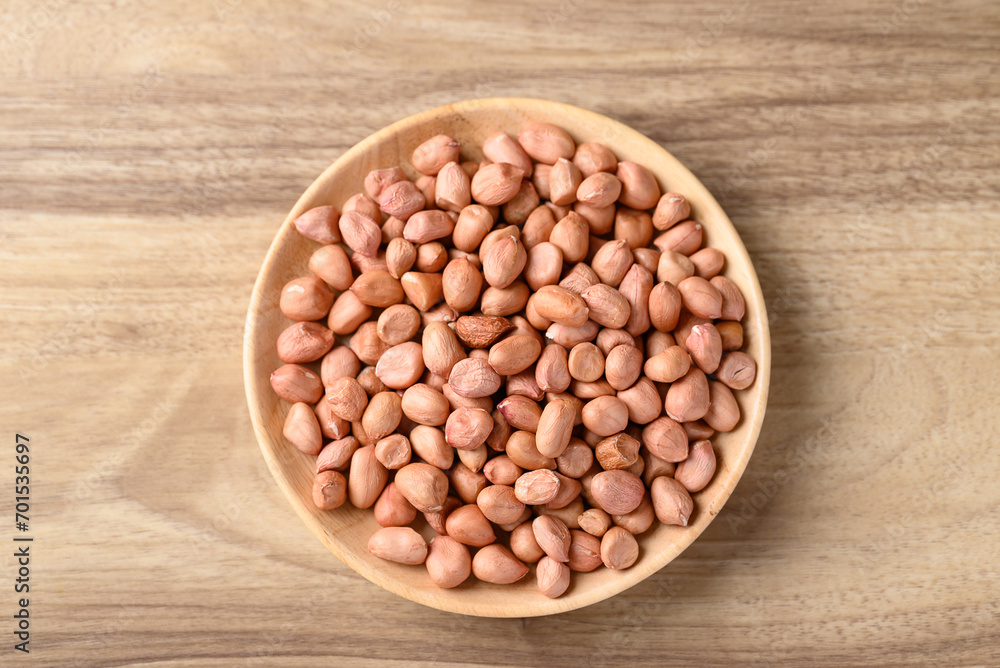 Peanut in bowl on wooden background, Table top view Peanut in bowl on wooden background, Table top view