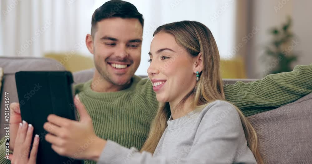 Home, love and couple on a couch, tablet and streaming movies with social media, email and conversation. Lounge, man or woman on a sofa, technology or app for fun, talking or search internet for info Home, love and couple on a couch, tablet and streaming movies with social media, email and conversation. Lounge, man or woman on a sofa, technology or app for fun, talking or search internet for info