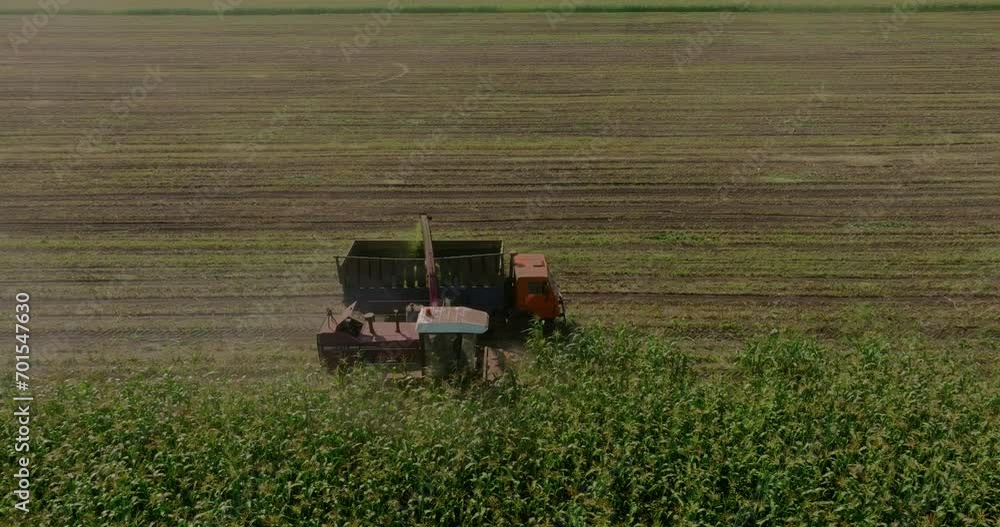 Work of agricultural machinery in harvest season, view from drone, low flight, cinematic shot, 4K, Prores Work of agricultural machinery in harvest season, view from drone, low flight, cinematic shot, 4K, Prores