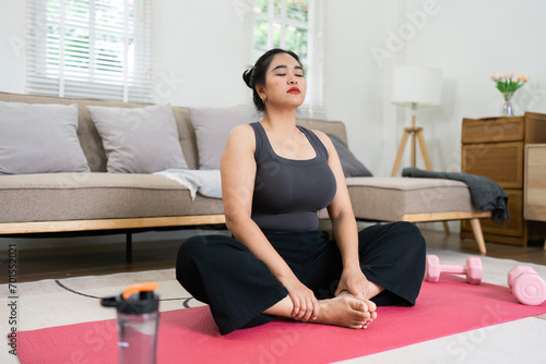 Cheerful attractive young overweight woman in activewear choosing healthy lifestyle