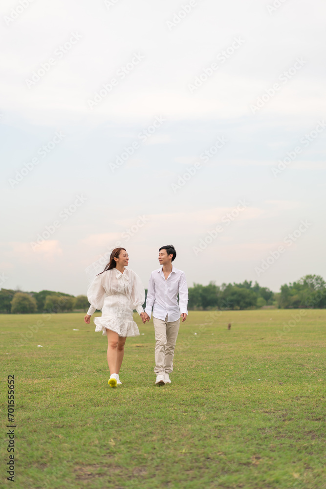 Happy young Asian couple in bride and groom clothing