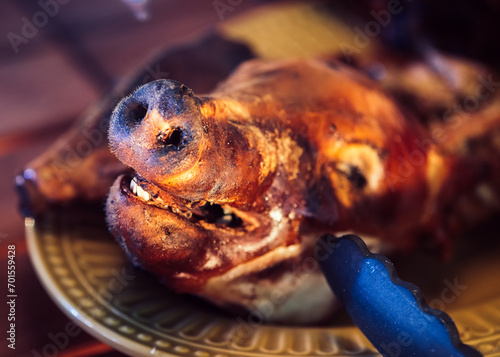 Barbecue pig head on white plate, top view photo