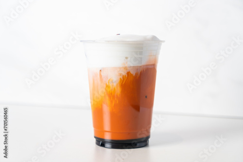 Thai tea with milk and bael on top photo