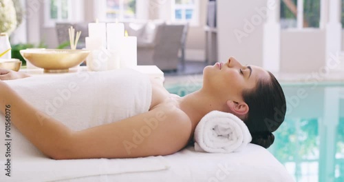 Spa, relax and woman on a massage table for wellness, peace and luxury body treatment. Travel, freedom and female client at a beauty resort for poolside physical therapy, peace or pamper in Thailand photo