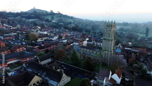 Aerial shot of Church with Glastonbury Tor in background photo