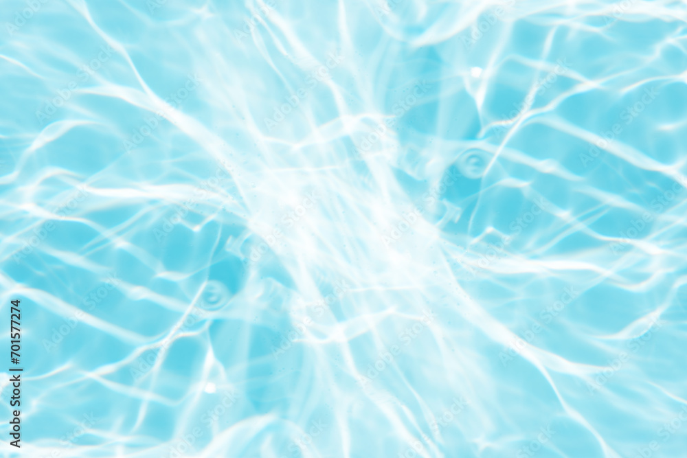 Bluewater waves on the surface ripples blurred. Defocus blurred transparent blue colored clear calm water surface texture with splash and bubbles. Water waves with shining pattern texture background. Bluewater waves on the surface ripples blurred. Defocus blurred transparent blue colored clear calm water surface texture with splash and bubbles. Water waves with shining pattern texture background.