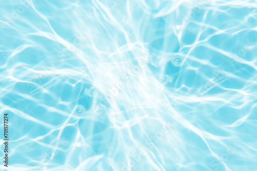 Bluewater waves on the surface ripples blurred. Defocus blurred transparent blue colored clear calm water surface texture with splash and bubbles. Water waves with shining pattern texture background.