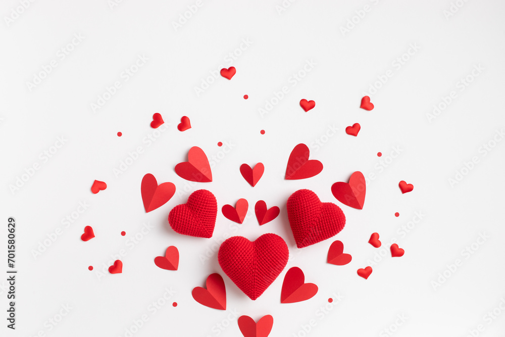 Valentine day festive pattern in shape of big heart for greeting card template with mixed homemade red paper and knitted hearts on white background top view and flat lay. Valentine day festive pattern in shape of big heart for greeting card template with mixed homemade red paper and knitted hearts on white background top view and flat lay.