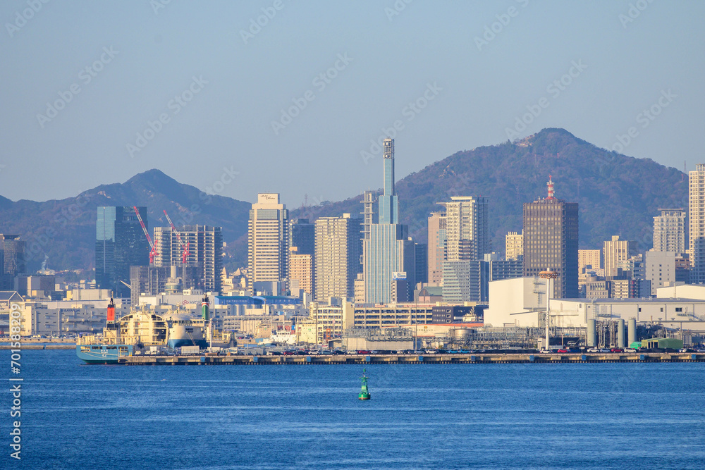 神戸の街並み。高層ビルが山と海に挟まれた景色。