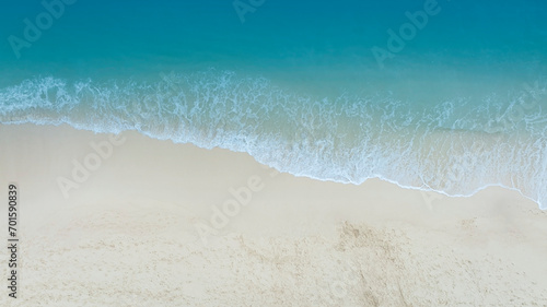Beach Wave water in the Tropical summer beach with  sandy beach background © SASITHORN