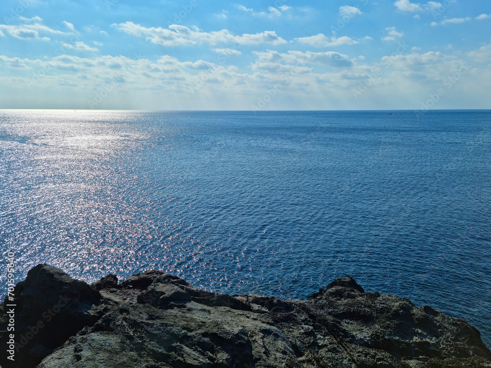 The blue sea and sky seen from the cliff.