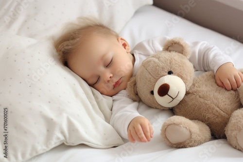 Adorable baby boy sleeping with teddy bear on bed at home, AI Generated