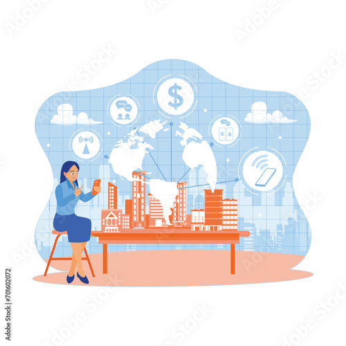 Woman sitting next to a miniature smart city. Using a smartphone with modern creative telecommunications and internet networks. Telecommunication and Internet in smart city concept.