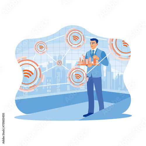 A businessman is standing holding a miniature city. Using modern creative networks and connected internet networks in smart cities. Telecommunication and Internet in smart city concept.