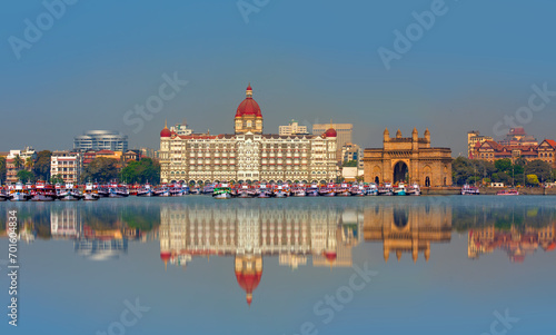 The Gateway of India and boats in the background Taj Mahal Hotel - Mumbai, India photo
