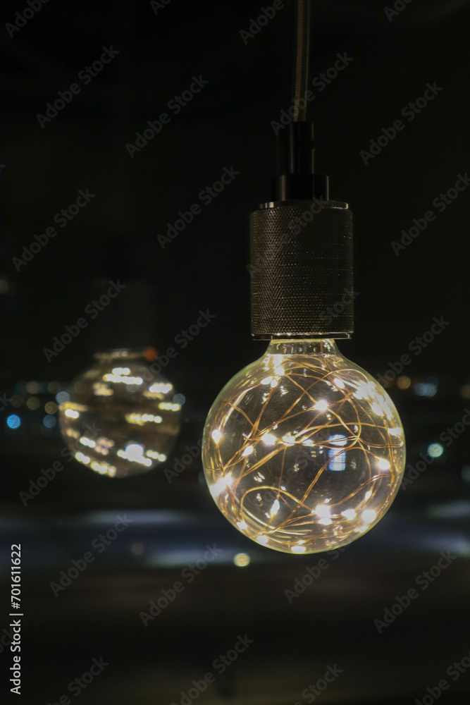 decorative beautiful light bulb in the dark night close up background