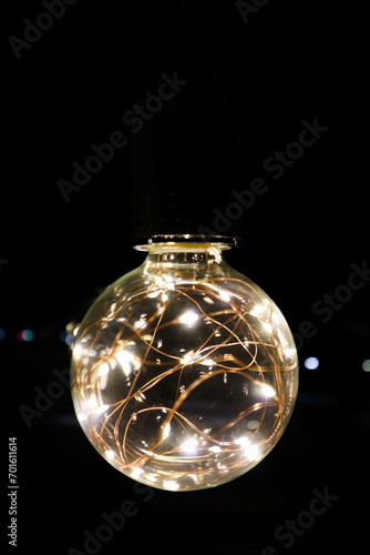 decorative beautiful light bulb in the dark night close up background