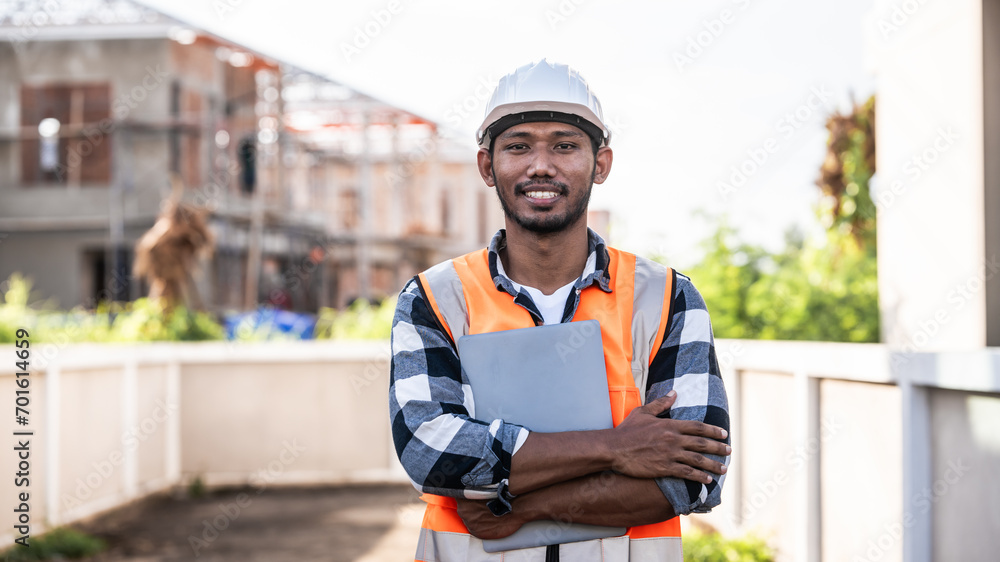 engineer in a high-visibility vest and hard hat, intently reviewing a document or blueprint, with a modern building in the background. engineer in a high-visibility vest and hard hat, intently reviewing a document or blueprint, with a modern building in the background.