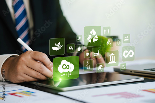 CO2. Concept showing the problem of carbon dioxide and CO2 emissions on the environment, global warming, sustainable development. Businessman investigates and solves world problems. Renewable energy photo