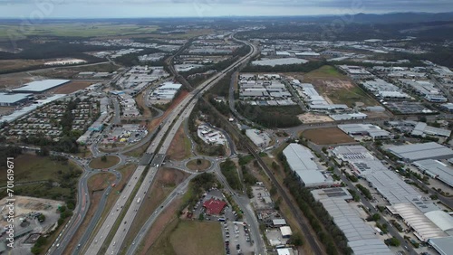 Daytime Traffic On Pacific Motorway In Yatala, Gold Coast, Queensland. aerial pullback shot photo