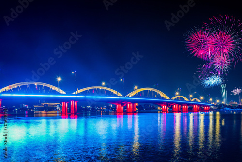 Fireworks celebrate the new year in Can Tho city, in front of the bridge with colorful circles in Quang Trung #701628213