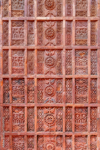 Closeup vertical view of delicate ancient terracotta carving with floral and geometric pattern on the facade of Atiya or Atia mosque, Tangail, Bangladesh photo