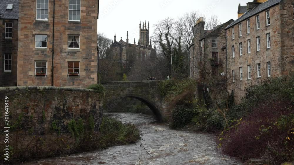 Water of Leith flowing through Dean Village in Edinburgh. Riverside buildings and stone arch bridge Water of Leith flowing through Dean Village in Edinburgh. Riverside buildings and stone arch bridge