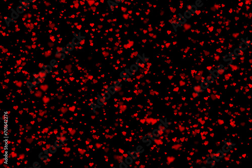 Blurred red heart shapes on black illustration background.
