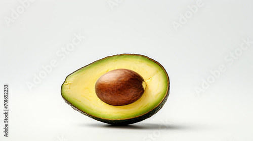 An avocado photographed alone on a plain white backdrop