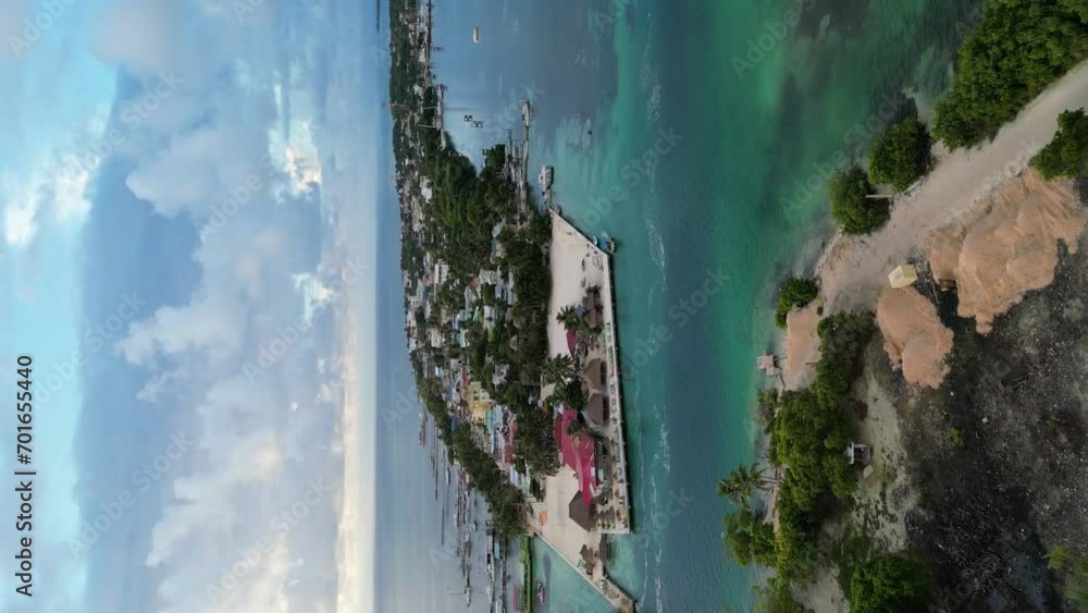 Drone portrait view in Belize flying over caribbean dark and light blue