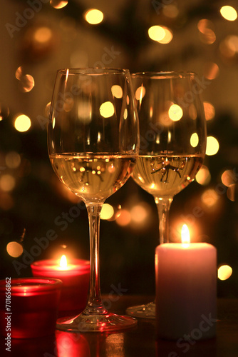 Burning candles and two glasses of white wine photo